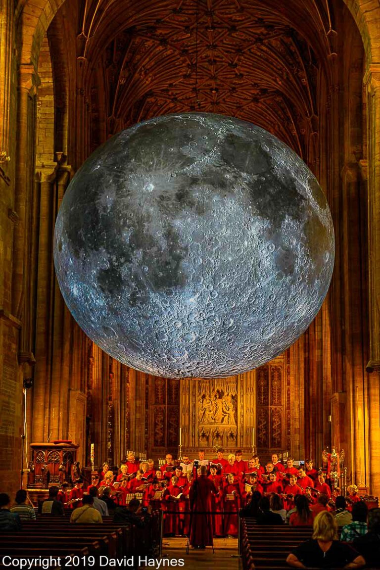 Museum of the Moon globe hanging in Shernorne Abbey with singing chior under.